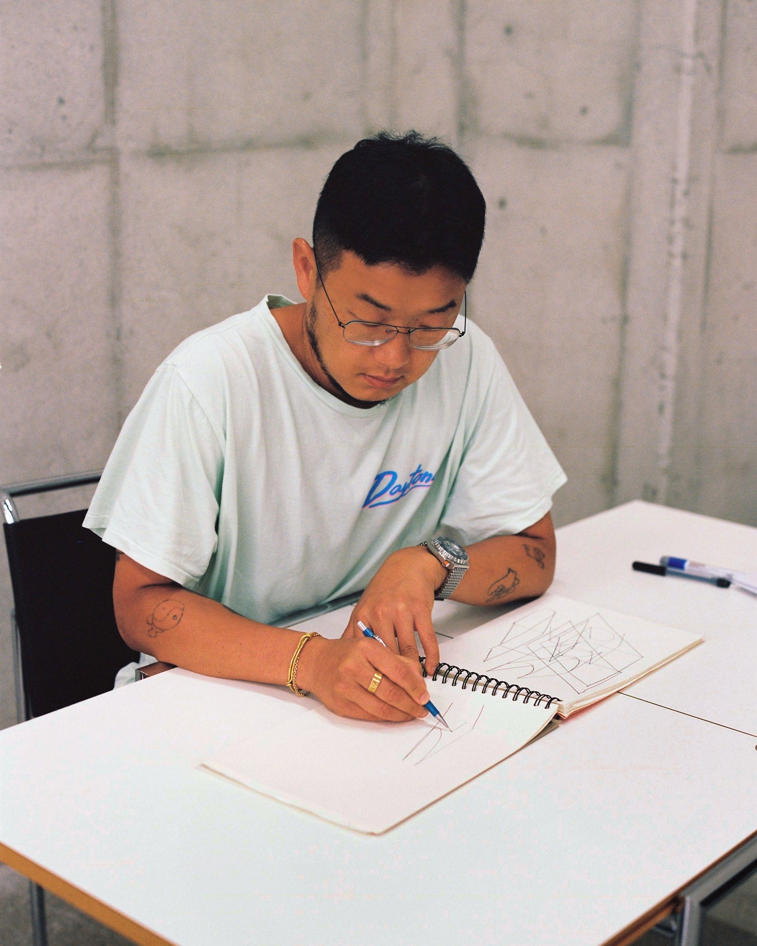 An editorial image from behind the scenes of making Hunk Lounge Chair and Glyph Side Tables by designer Kwangho Lee.