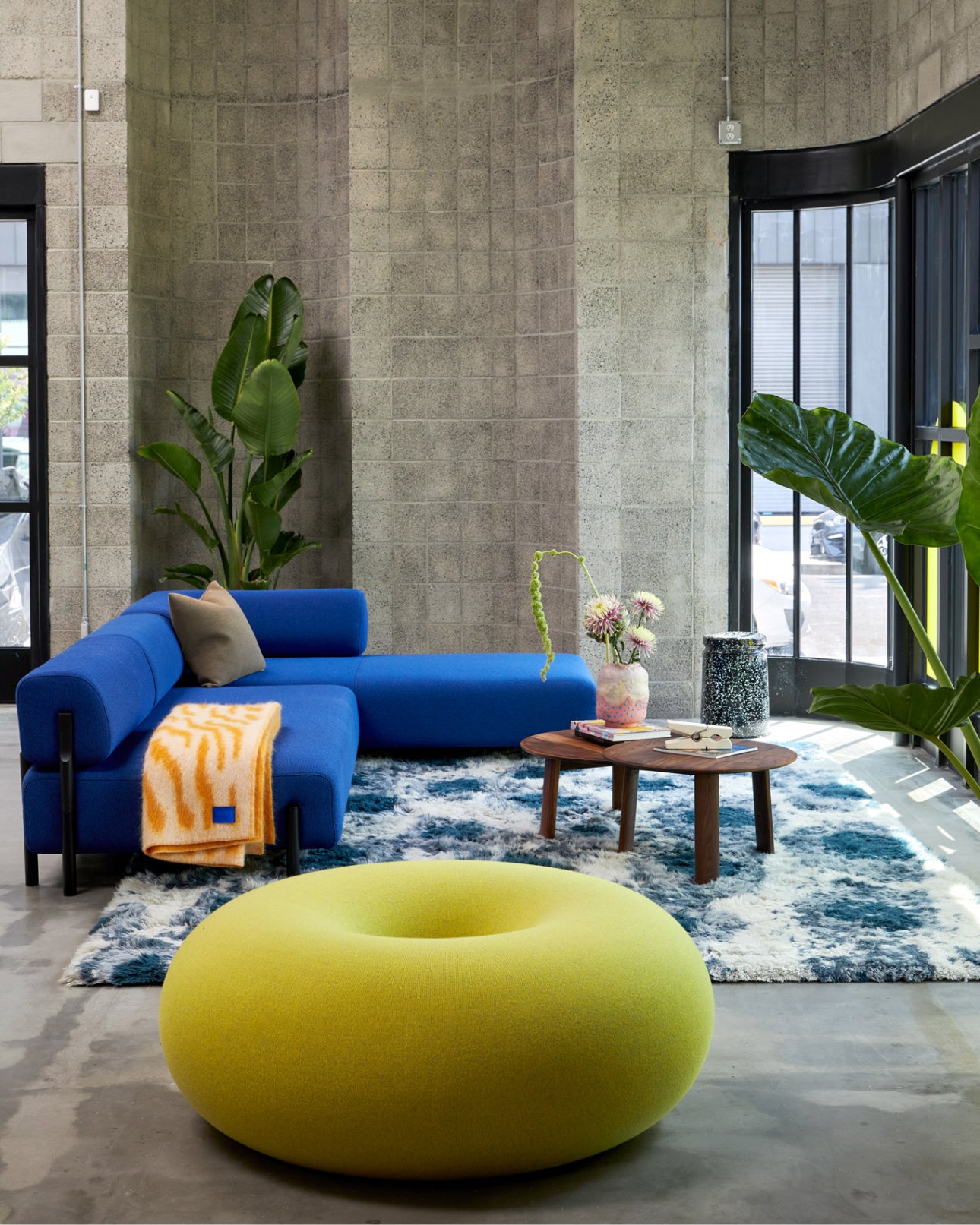 Hem - An inside view of our new LA showroom featuring Boa Pouf, Palo Corner Sofa Left, Monster Rug, Monster Throw, Alle Coffee Tables, Last Stools, and more.