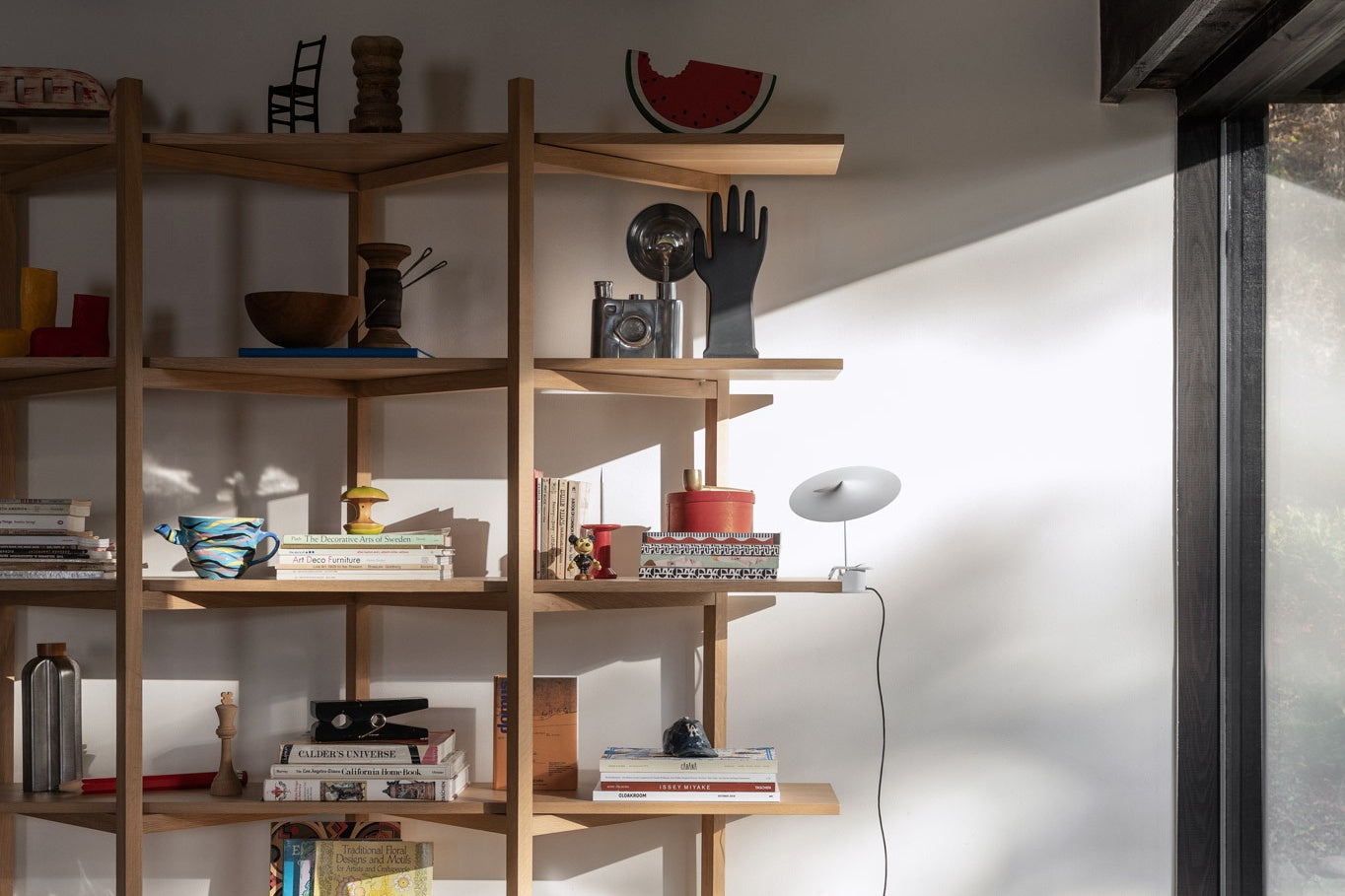 Zig Zag High Shelf in Oak filled with books and other decorative objects.